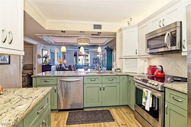 kitchen with white cabinets, stainless steel appliances, and light wood-type flooring