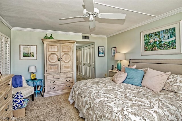 carpeted bedroom featuring a closet, ornamental molding, and ceiling fan