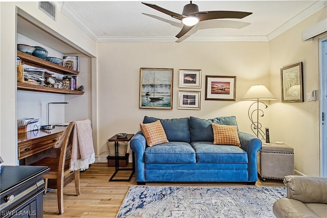 living room with ornamental molding, ceiling fan, and light wood-type flooring