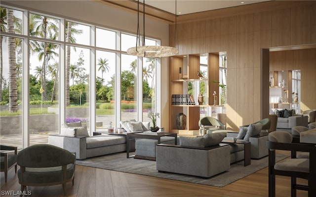 living room with a high ceiling and wooden walls