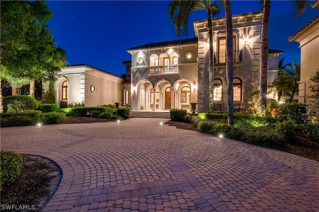 mediterranean / spanish house featuring french doors and a balcony