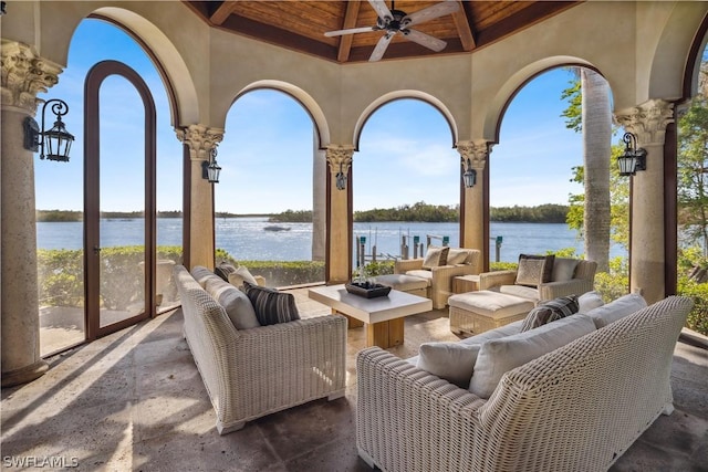 view of patio / terrace with a water view, ceiling fan, and an outdoor living space