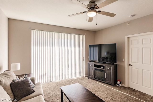 carpeted living room featuring ceiling fan