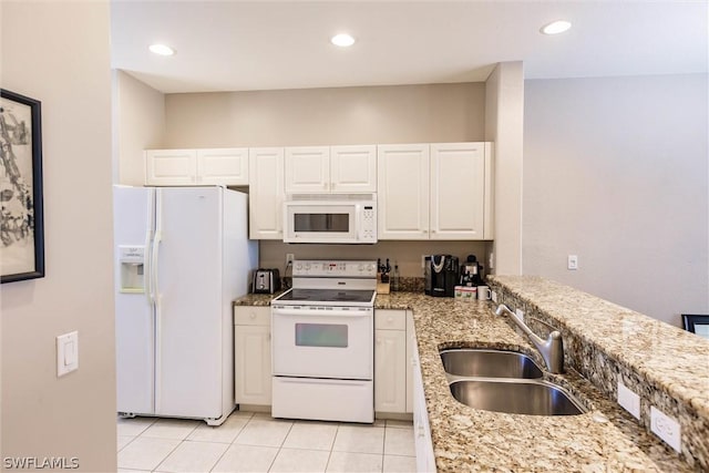 kitchen featuring white appliances, sink, white cabinets, light tile flooring, and light stone countertops