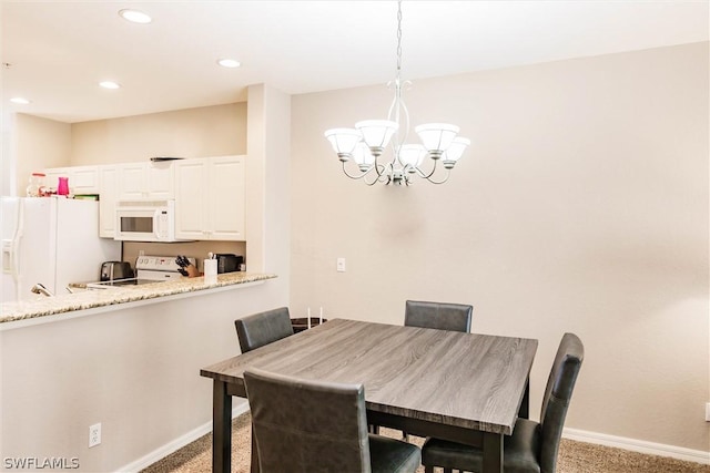 carpeted dining room featuring a notable chandelier