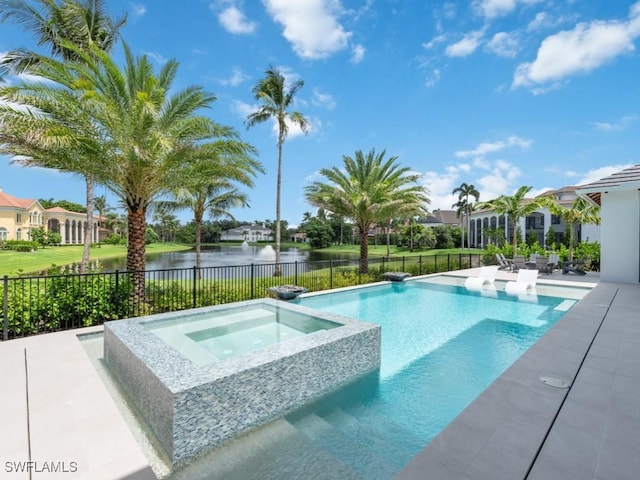 view of swimming pool with a pool with connected hot tub, a water view, a patio area, fence, and a residential view
