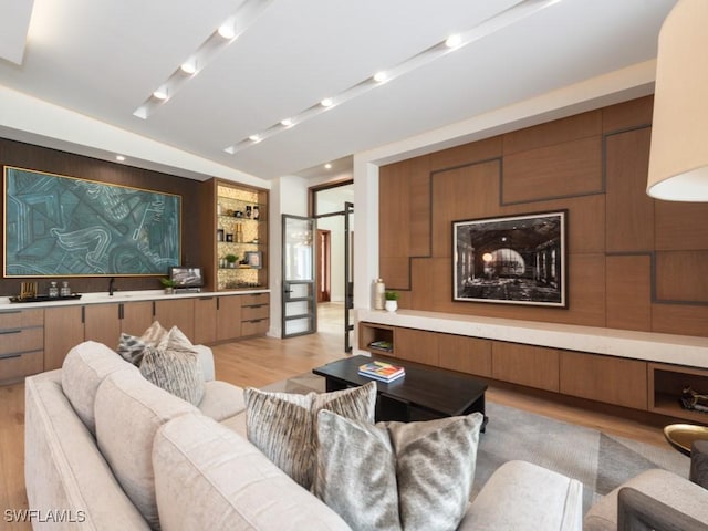 interior space with a sink, built in features, and light wood-style floors