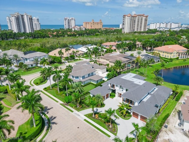 birds eye view of property featuring a water view and a city view