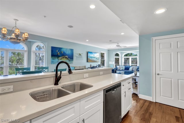 kitchen featuring ceiling fan with notable chandelier, dark wood-type flooring, white cabinets, dishwasher, and sink