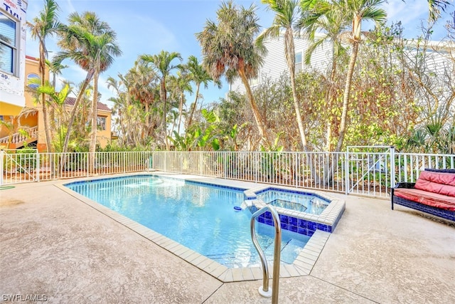 view of pool with an in ground hot tub and a patio area