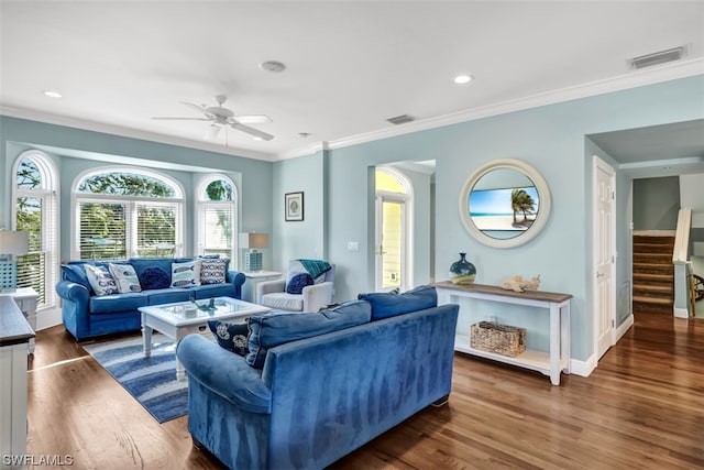 living room with crown molding, dark hardwood / wood-style flooring, and ceiling fan