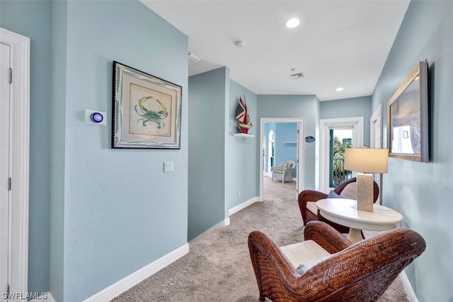 sitting room with light colored carpet