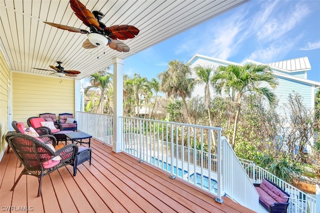 wooden deck with an outdoor hangout area and ceiling fan