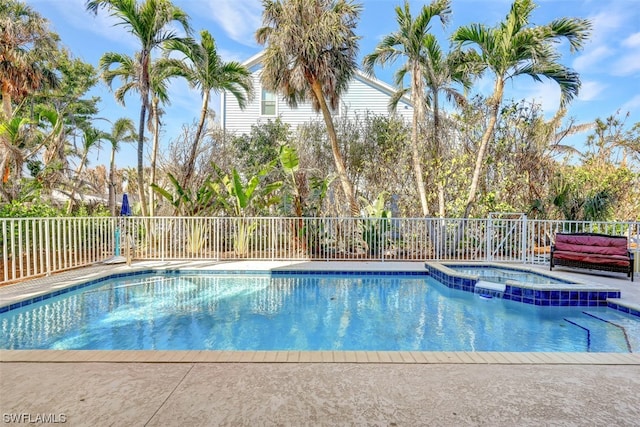 view of swimming pool featuring an in ground hot tub