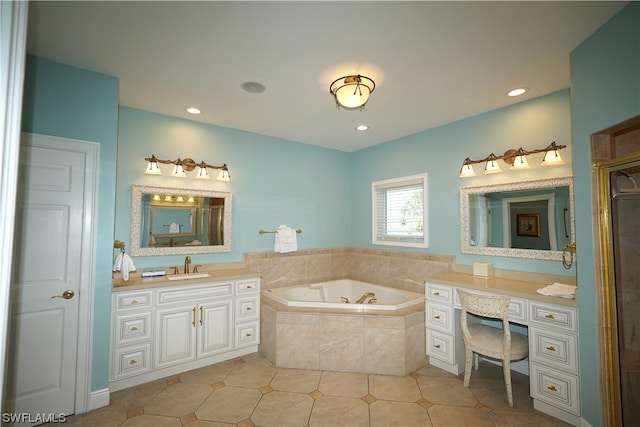 bathroom featuring tiled bath, tile flooring, and vanity