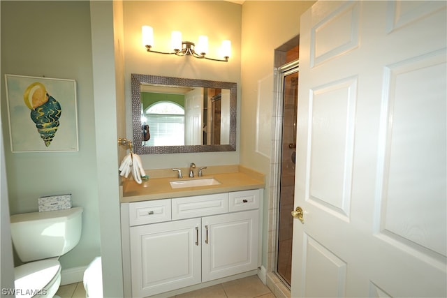 bathroom with tile floors, toilet, vanity, and a shower with door