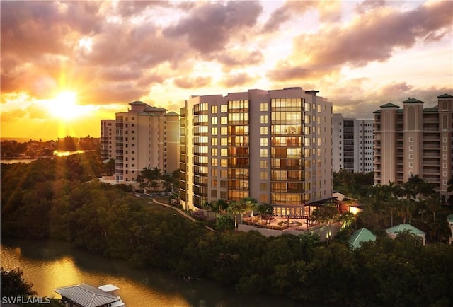 view of building exterior with a water view and a view of city