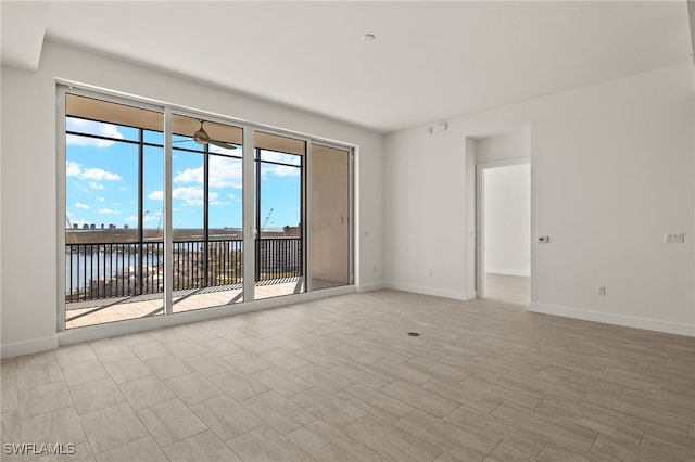 unfurnished room featuring light wood-type flooring and baseboards