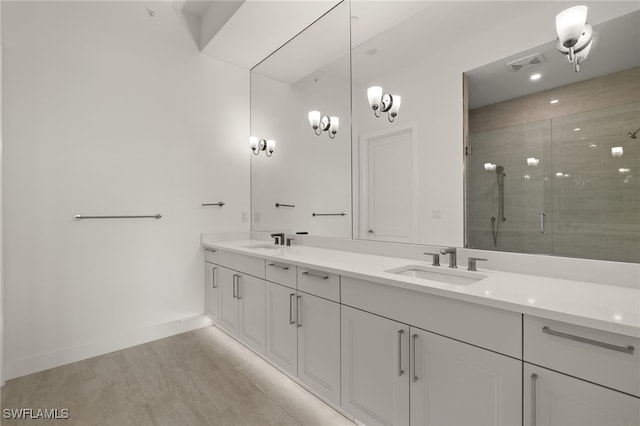 full bath with double vanity, a stall shower, visible vents, and a sink