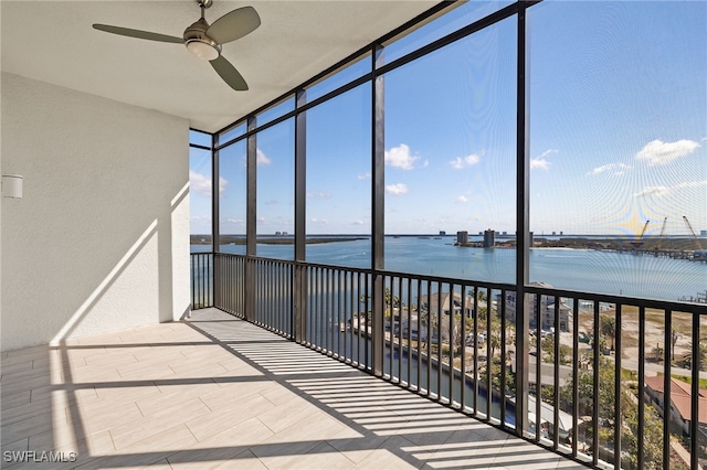 unfurnished sunroom featuring a water view