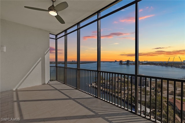 unfurnished sunroom with a water view