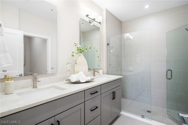 bathroom featuring vanity and a shower with door