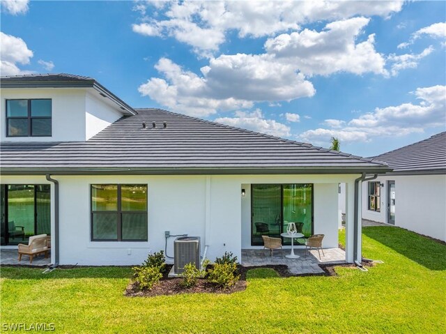 rear view of house featuring a patio area, a yard, and central AC unit