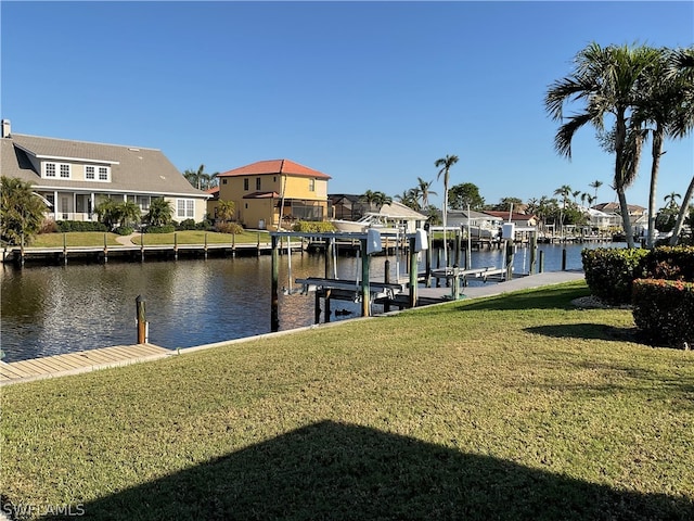 view of dock featuring a water view and a yard