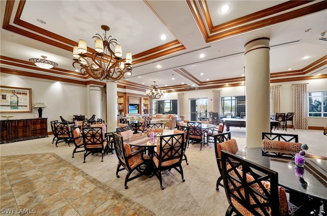 dining area with an inviting chandelier, decorative columns, and a tray ceiling