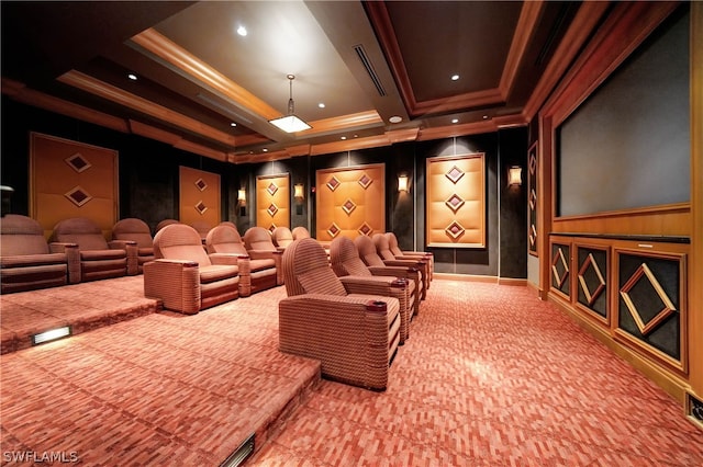 home theater with a tray ceiling, crown molding, and carpet floors