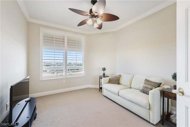 carpeted living area with a ceiling fan, crown molding, and baseboards