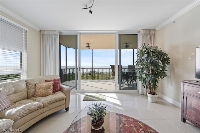 living room with a water view, floor to ceiling windows, light tile patterned floors, and ornamental molding