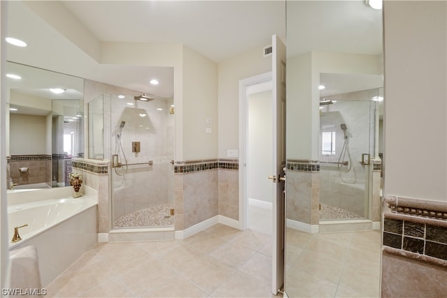 full bath with tile patterned floors, visible vents, a stall shower, and a garden tub