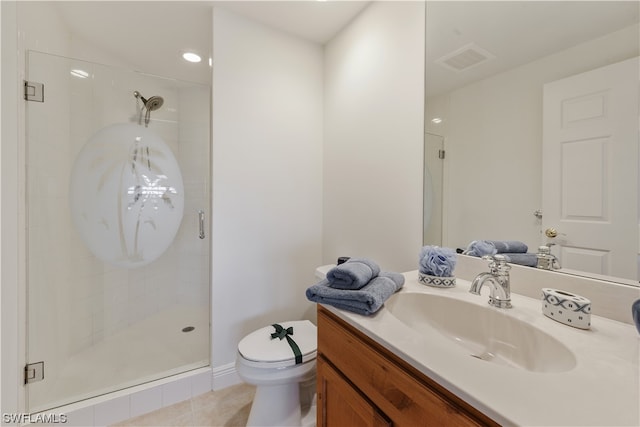 bathroom featuring vanity, toilet, a shower with shower door, and tile patterned floors