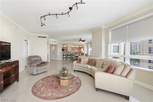 living area featuring tile patterned flooring, visible vents, crown molding, and baseboards