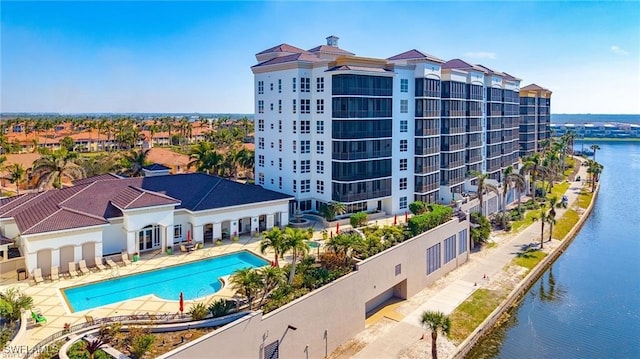 view of property featuring a water view and a community pool