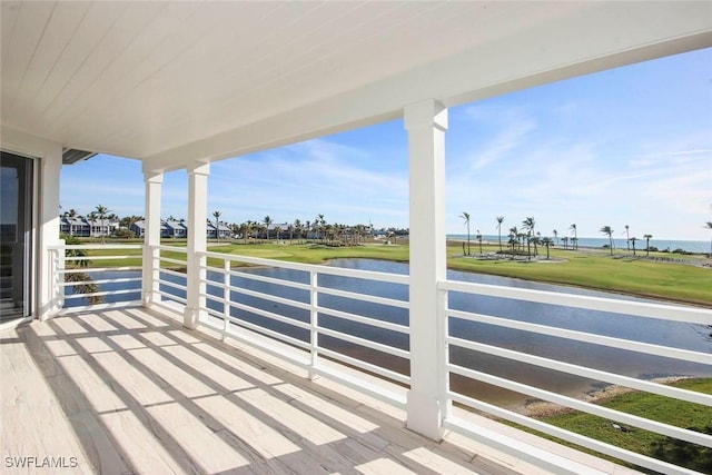 view of patio featuring a water view and a balcony