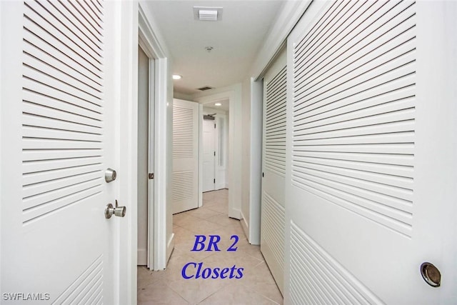 corridor featuring light tile patterned floors