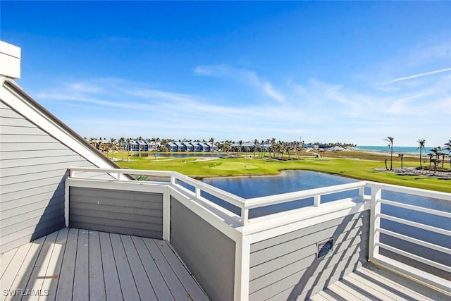 wooden terrace featuring a water view