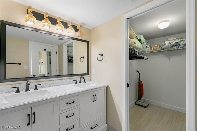 bathroom with hardwood / wood-style floors and vanity