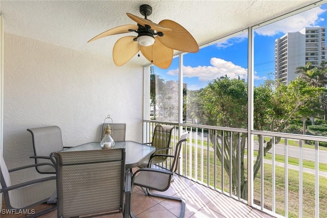 sunroom featuring ceiling fan and a healthy amount of sunlight