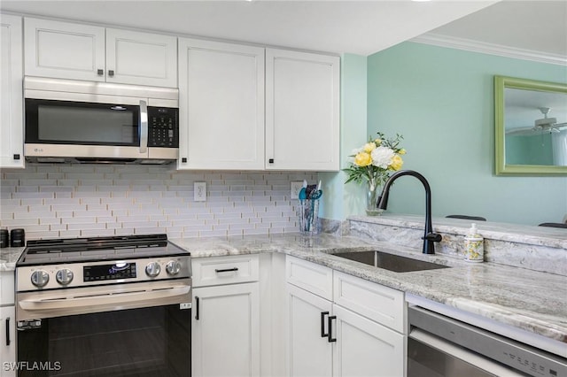 kitchen featuring white cabinetry, sink, ornamental molding, and appliances with stainless steel finishes