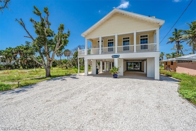 coastal inspired home with a carport and a porch