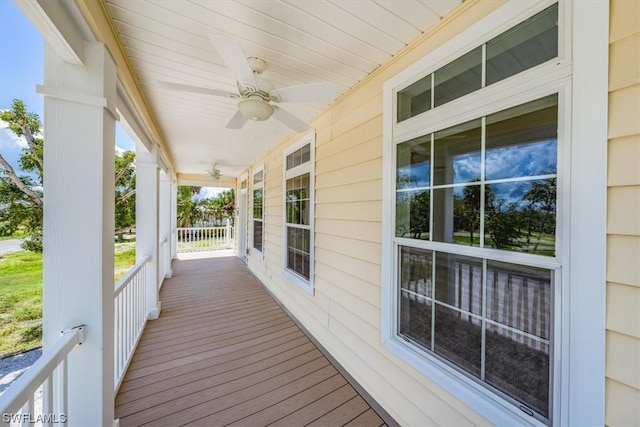 deck with ceiling fan and covered porch