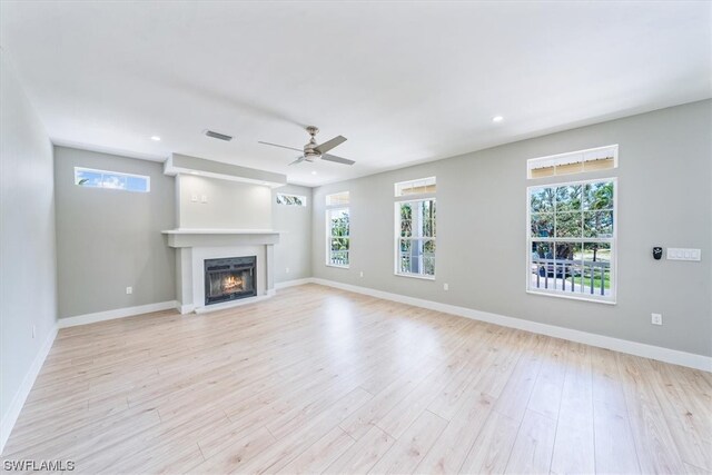 unfurnished living room with light hardwood / wood-style floors and ceiling fan