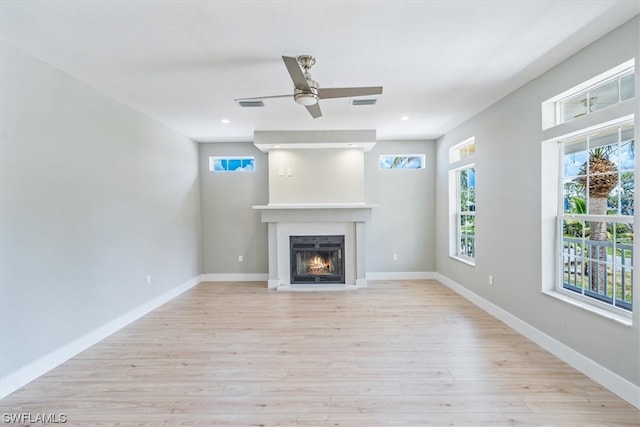 unfurnished living room featuring light hardwood / wood-style floors and ceiling fan