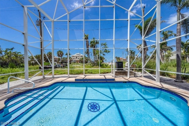 view of swimming pool with a lanai and a patio