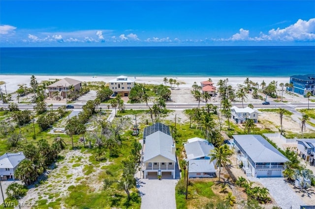 bird's eye view featuring a view of the beach and a water view