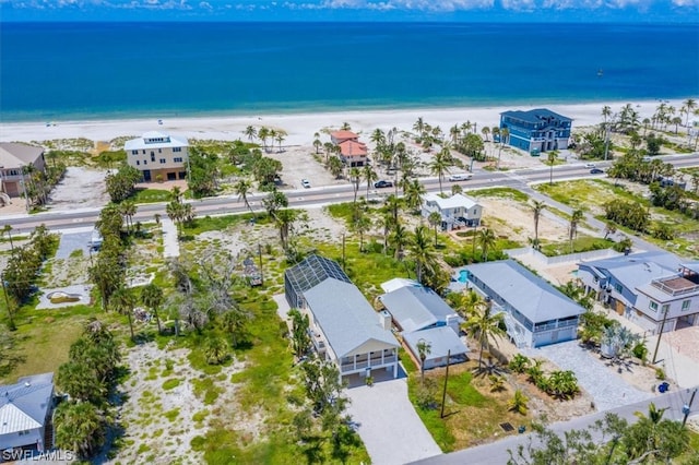 drone / aerial view with a water view and a beach view