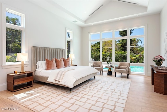 bedroom featuring recessed lighting, high vaulted ceiling, and light wood-style floors